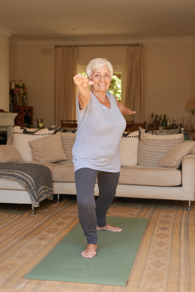 Woman doing private yoga classes in her home